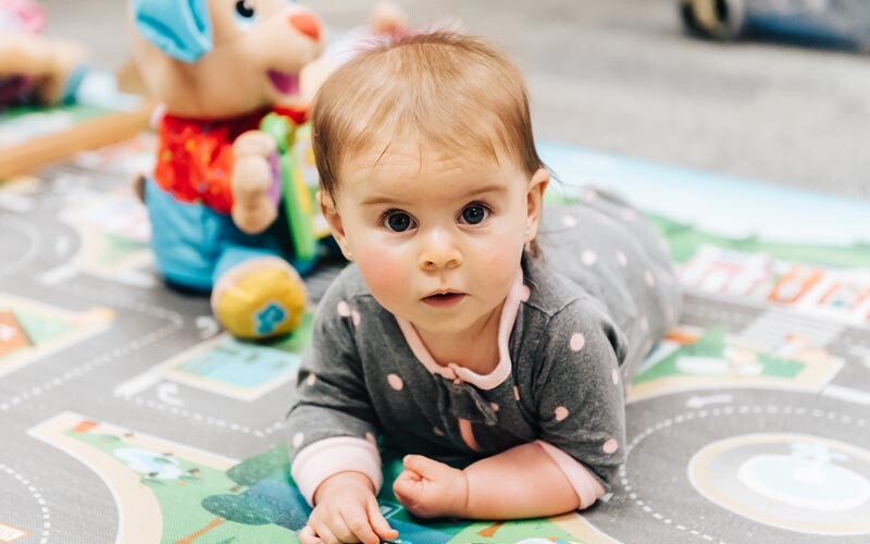 Baby during tummy time in the infant classroom at Beary Cherry Tree in Metairie