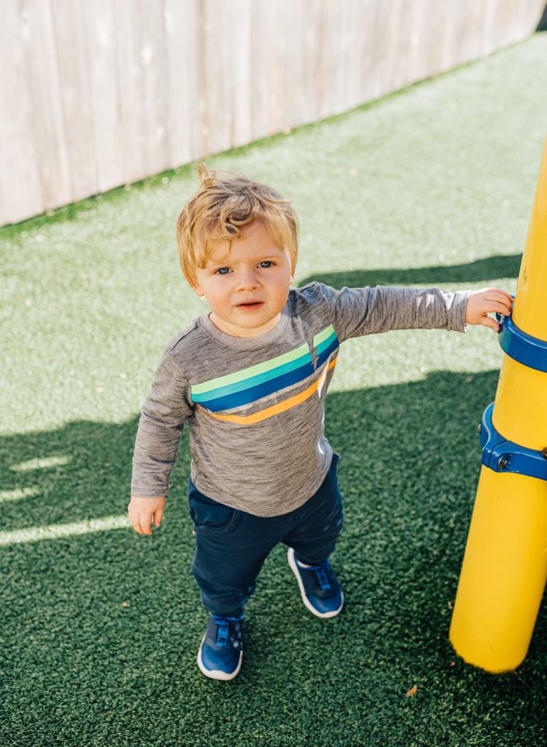 Toddler playing outside on the playground at Beary Cherry Tree in Metairie